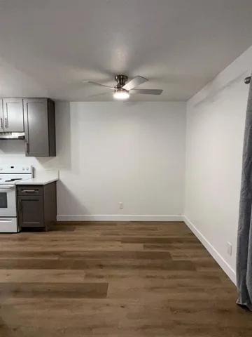 a view of kitchen with cabinets and wooden floor