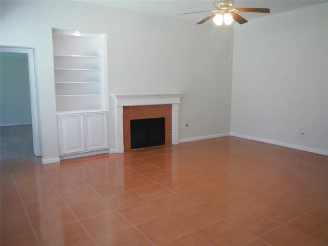 en empty room with closet and a fireplace