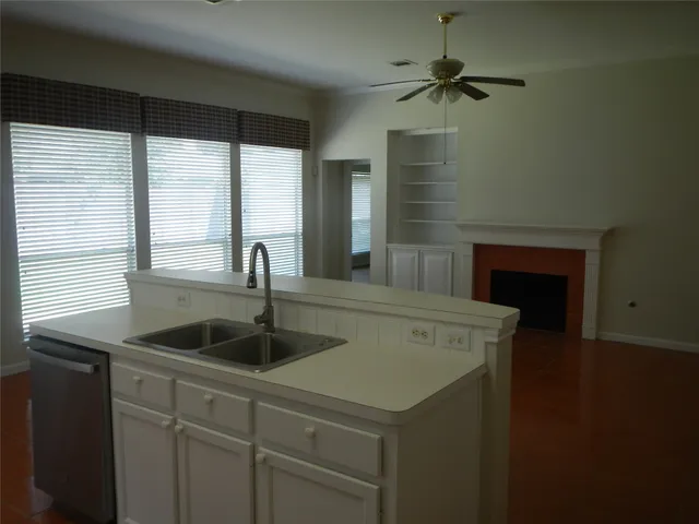 a kitchen with a sink and a chandelier