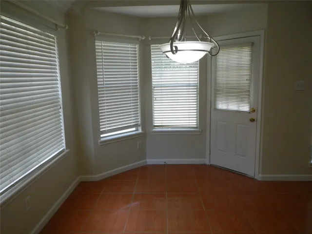 a room that has a window and a table in it