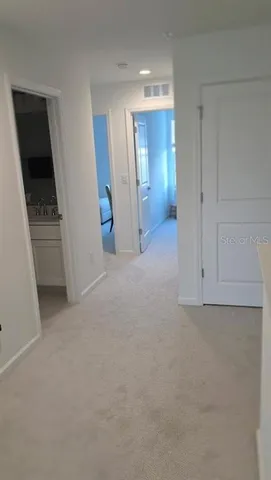 an empty room with closet and mirror