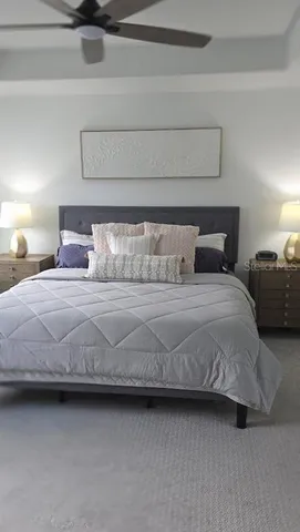 a bedroom with a bed and lamp