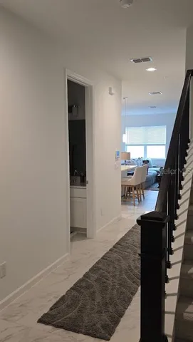 a view of entryway and hall with wooden floor
