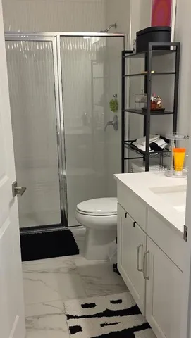 a bathroom with a sink toilet and shower