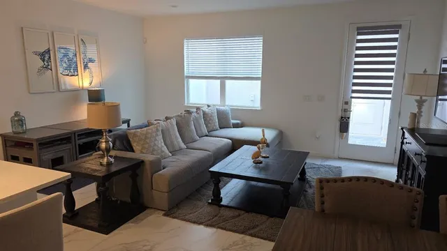 a living room with furniture and a window