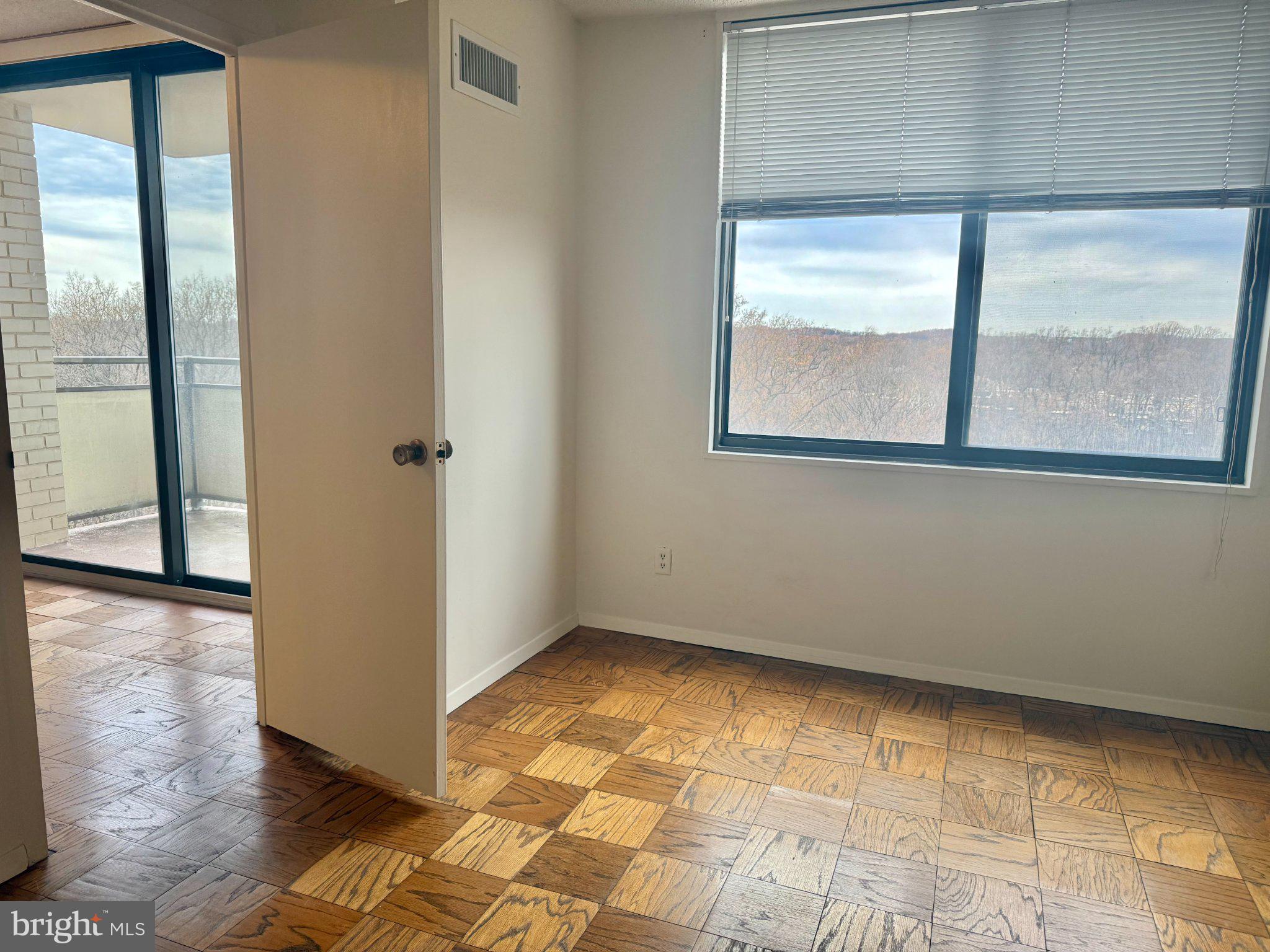 5225 Pooks Hill Road, Unit 1326 Bethesda, MD 20814 - Photo 12 of 24 a view of an empty room with wooden floor and a window