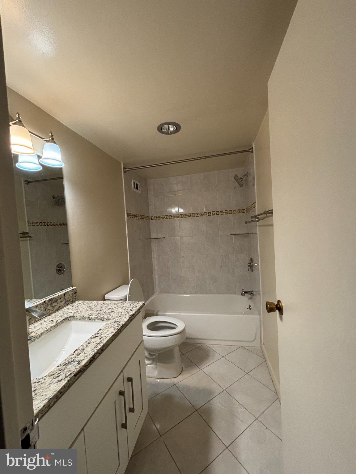 5225 Pooks Hill Road, Unit 1326 Bethesda, MD 20814 - Photo 18 of 24 a bathroom with a granite countertop sink a toilet and shower