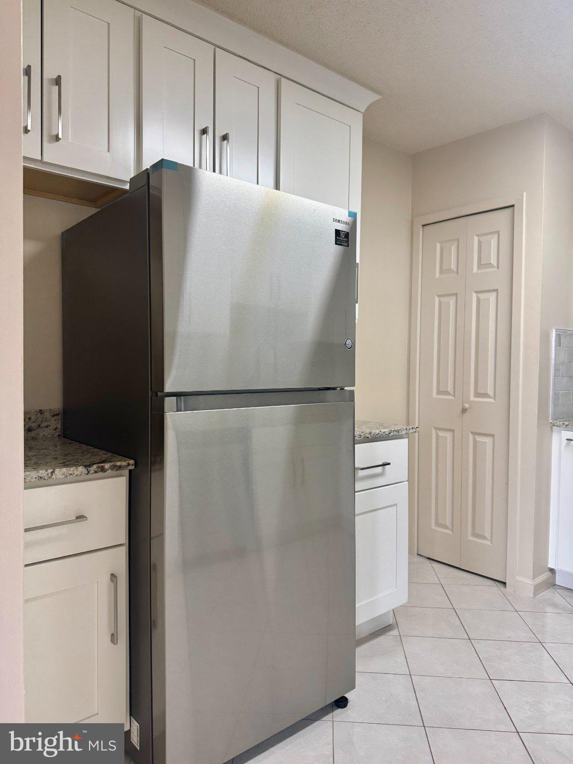 5225 Pooks Hill Road, Unit 1326 Bethesda, MD 20814 - Photo 6 of 24 a white refrigerator freezer and a stove sitting inside of a kitchen