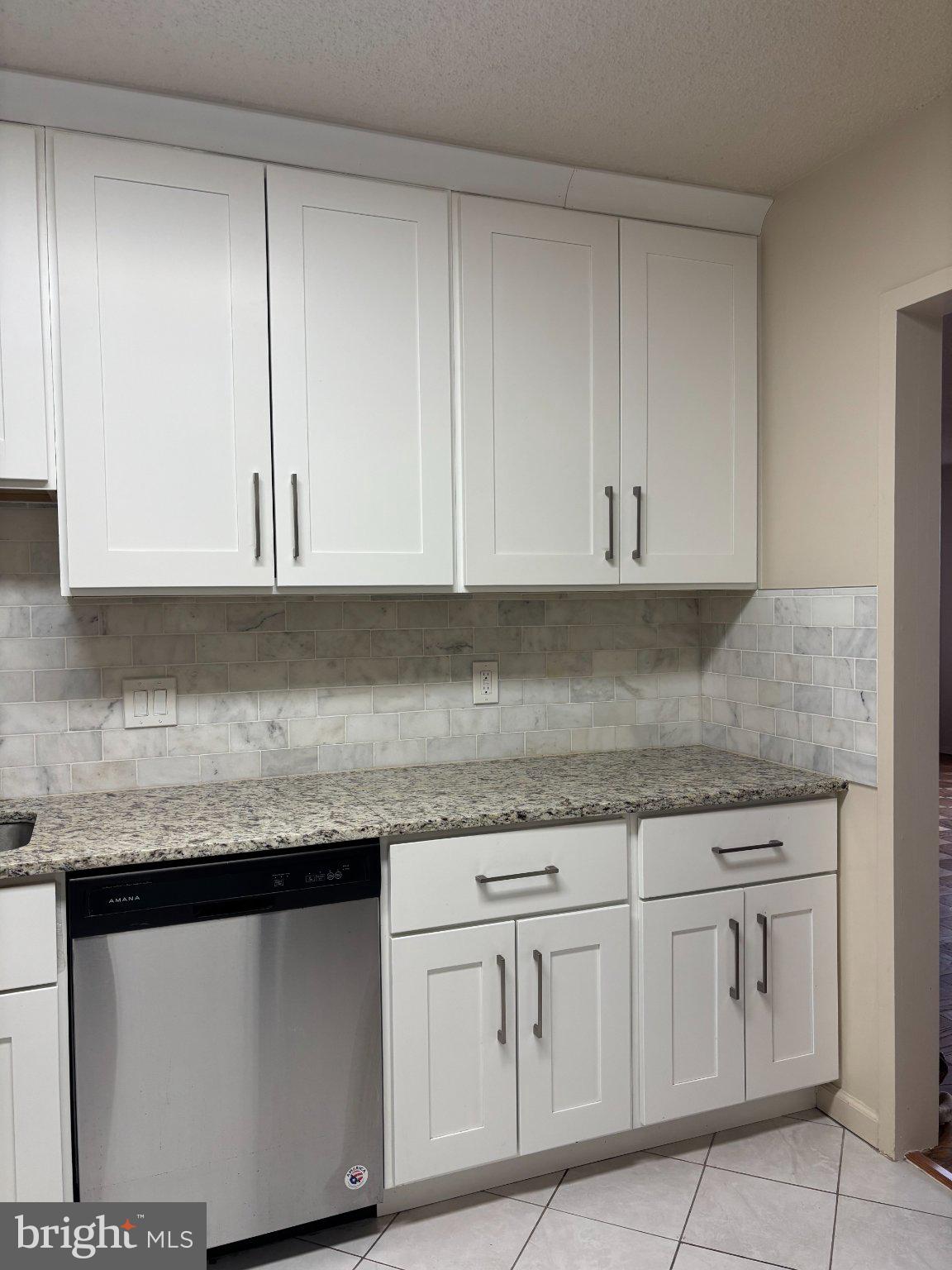 5225 Pooks Hill Road, Unit 1326 Bethesda, MD 20814 - Photo 7 of 24 a kitchen with granite countertop white cabinets and a sink