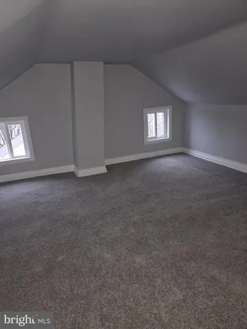 an empty room with a empty space and windows