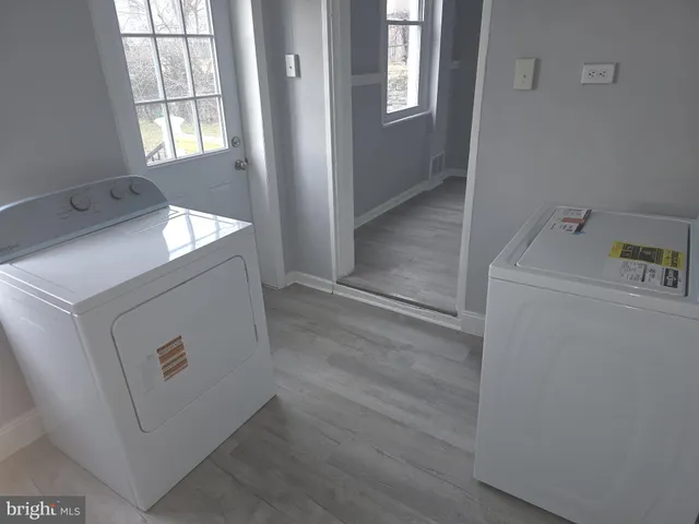 a utility room with closet dryer and washer