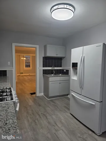 a kitchen with stainless steel appliances a refrigerator sink and stove