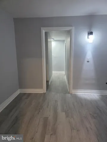 a view of hallway with wooden floor