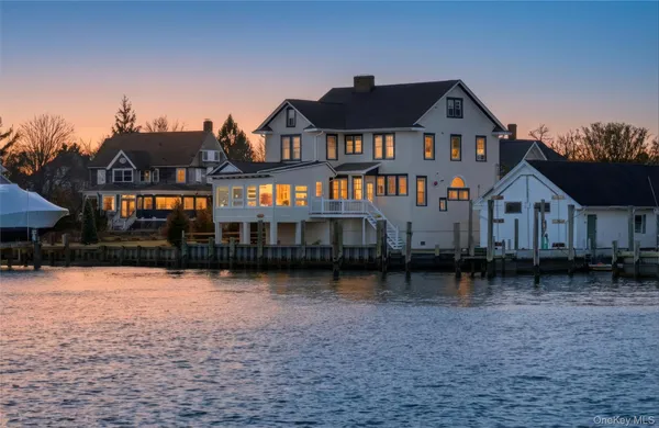 a front view of a house with yard and balcony