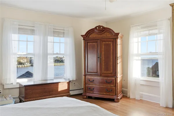 a spacious bedroom with a bed dresser and a window