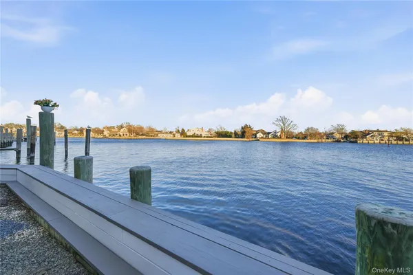 a view of a balcony with lake view and wooden floor
