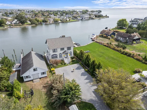 an aerial view of a house with a lake view