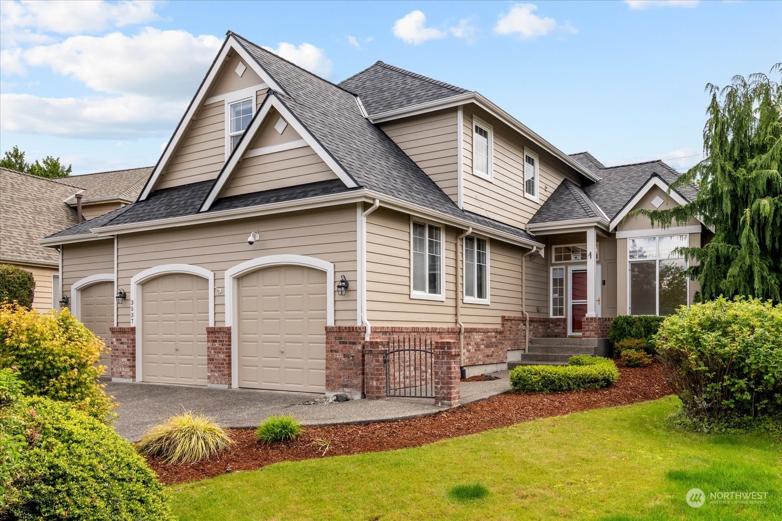 3537 Northeast 24th Court Renton, WA 98056 - Photo 3 of 39 a front view of a house with a yard