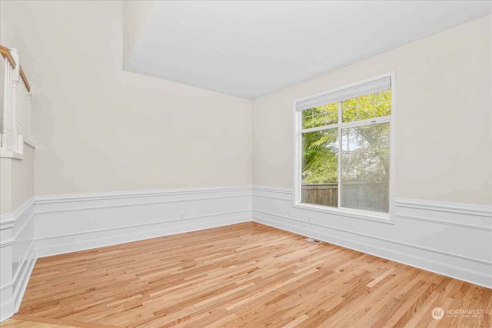 3537 Northeast 24th Court Renton, WA 98056 - Photo 7 of 39 a view of an empty room with wooden floor and a window