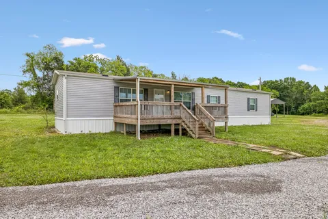 a view of a house with a backyard
