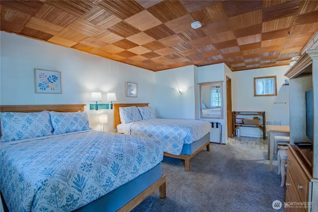 a large bedroom with bed and a chandelier