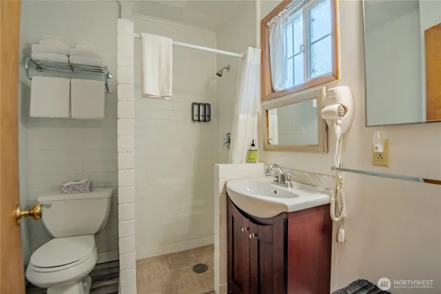 a bathroom with a toilet sink and mirror