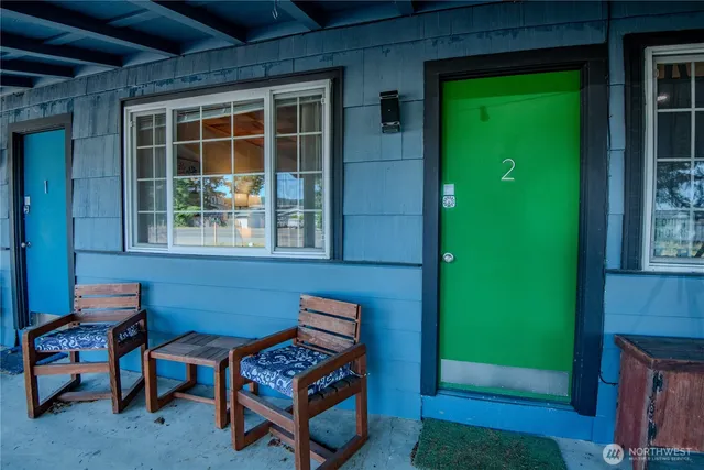 a building outdoor space with patio furniture and potted plants