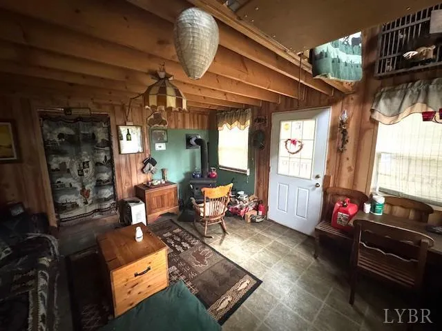 a living room with furniture gym equipment and a large window