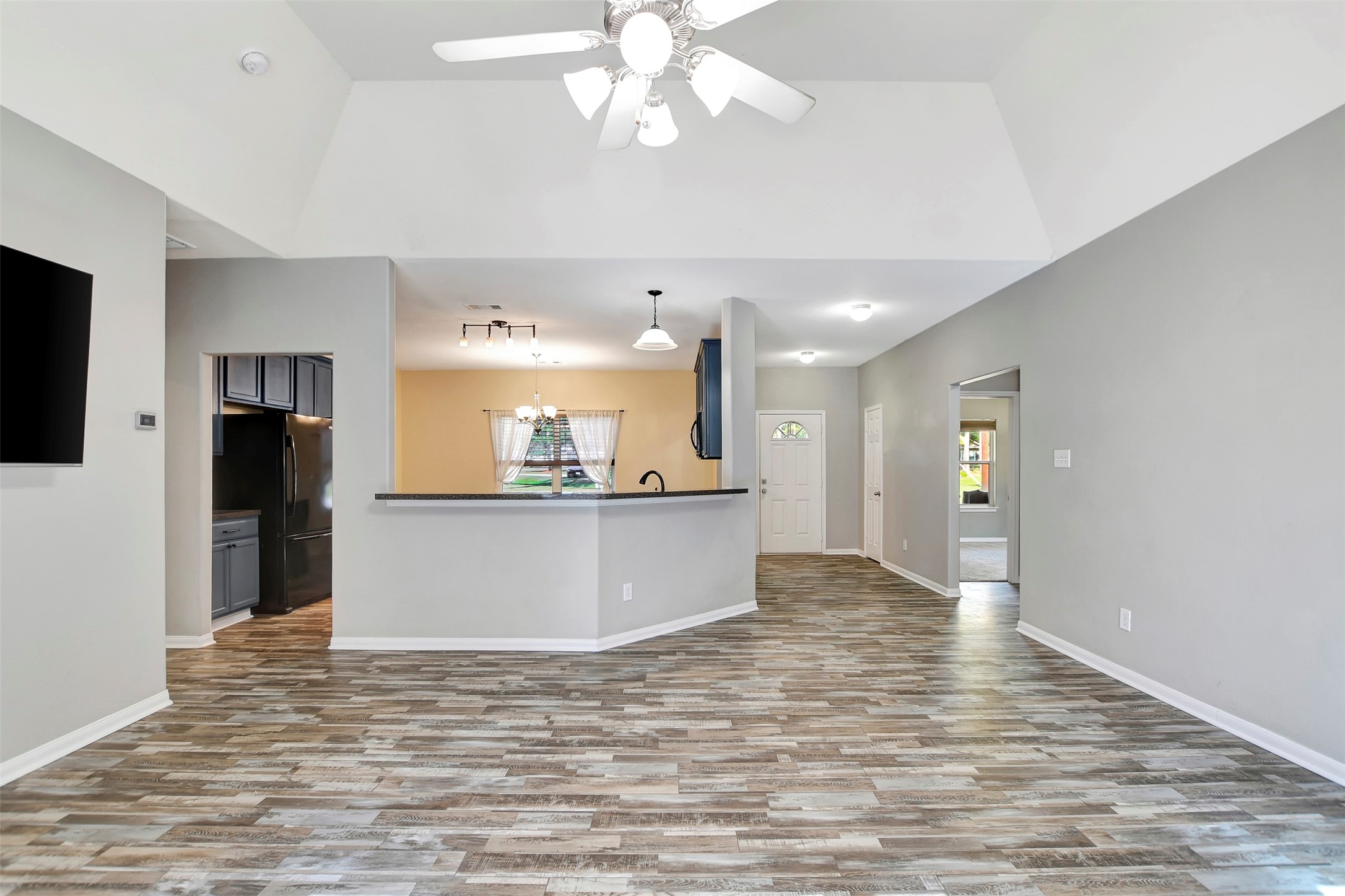 25896 Lake View Court West Hockley, TX 77447 - Photo 11 of 47 a view of kitchen and empty room with wooden floor