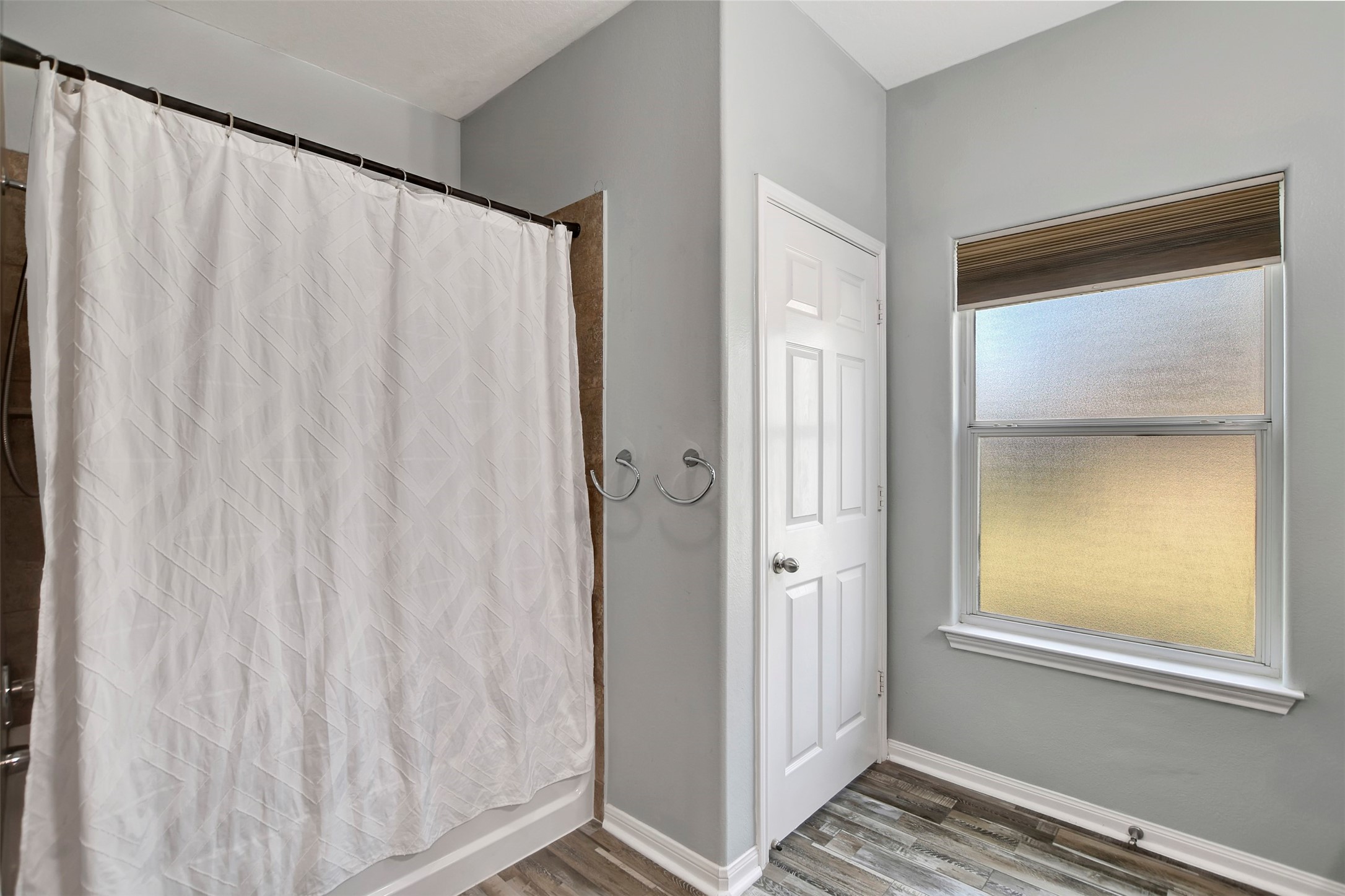 25896 Lake View Court West Hockley, TX 77447 - Photo 26 of 47 a view of a bathroom with a shower curtain and a window