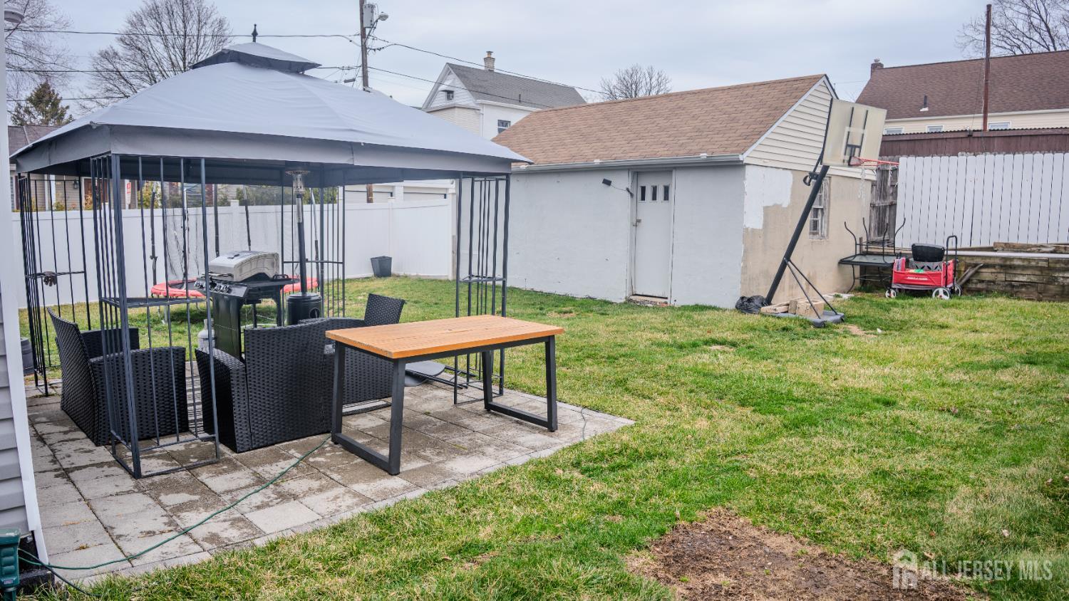 636 Lee Street Perth Amboy, NJ 08861 - Photo 15 of 35 a view of a house with backyard and a wooden fence