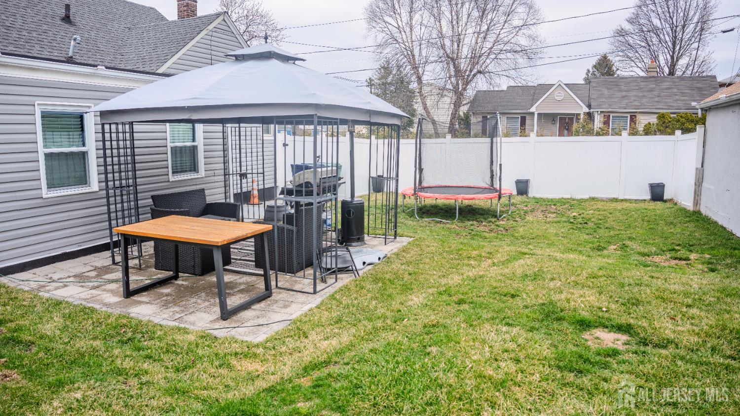 636 Lee Street Perth Amboy, NJ 08861 - Photo 17 of 35 a backyard of a house with table and chairs