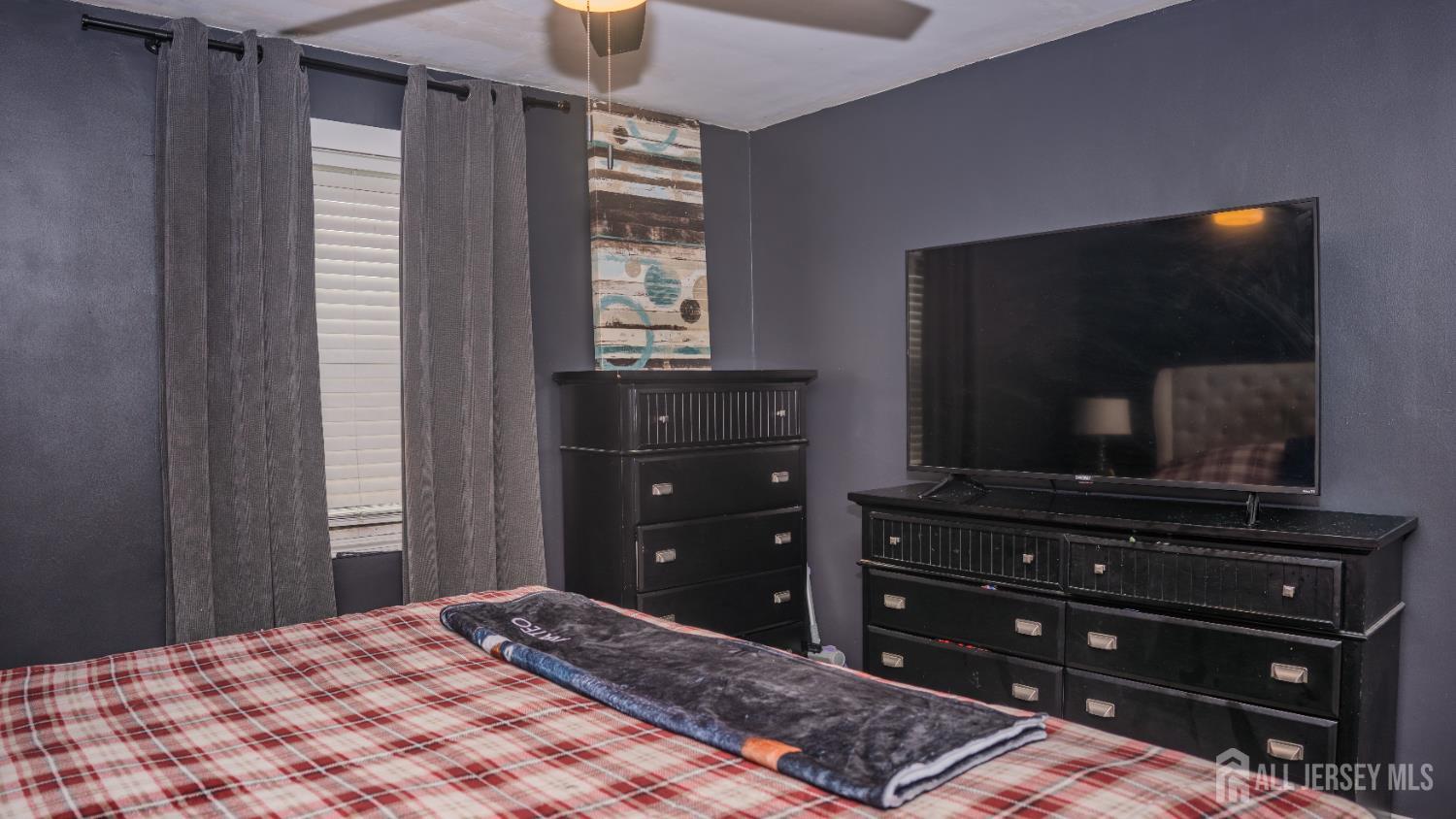 636 Lee Street Perth Amboy, NJ 08861 - Photo 28 of 35 a bedroom with a bed and a flat screen tv