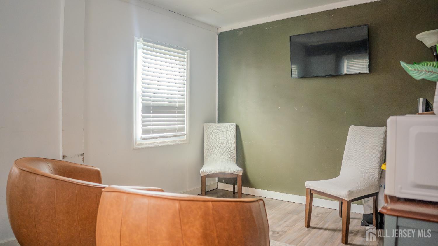 636 Lee Street Perth Amboy, NJ 08861 - Photo 7 of 35 a room with a window and a chair