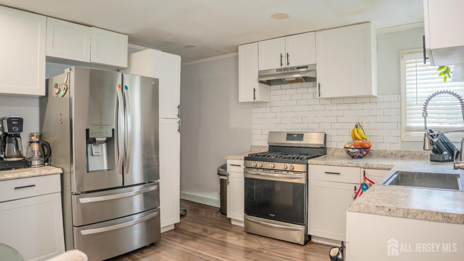 636 Lee Street Perth Amboy, NJ 08861 - Photo 9 of 35 a kitchen with stainless steel appliances granite countertop a refrigerator stove and sink
