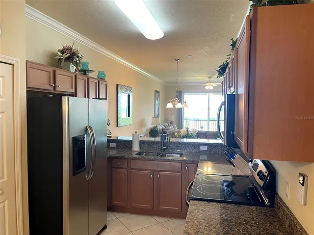 a kitchen with stainless steel appliances granite countertop a refrigerator and a sink