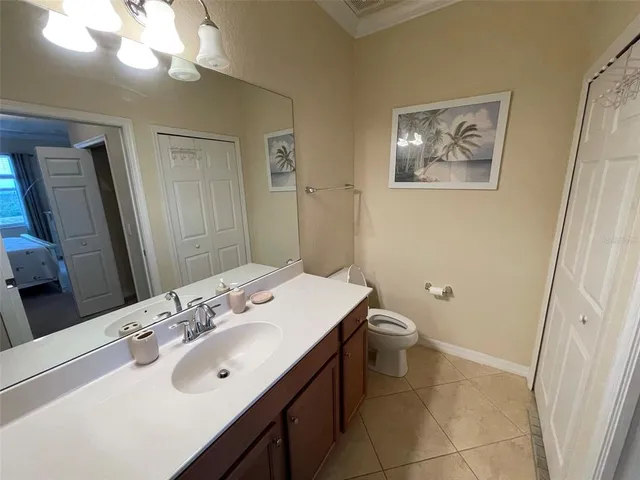 a bathroom with a sink a toilet and mirror