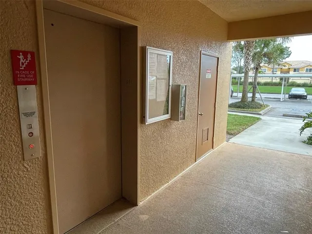 a view of a porch with a floor to ceiling window and a yard
