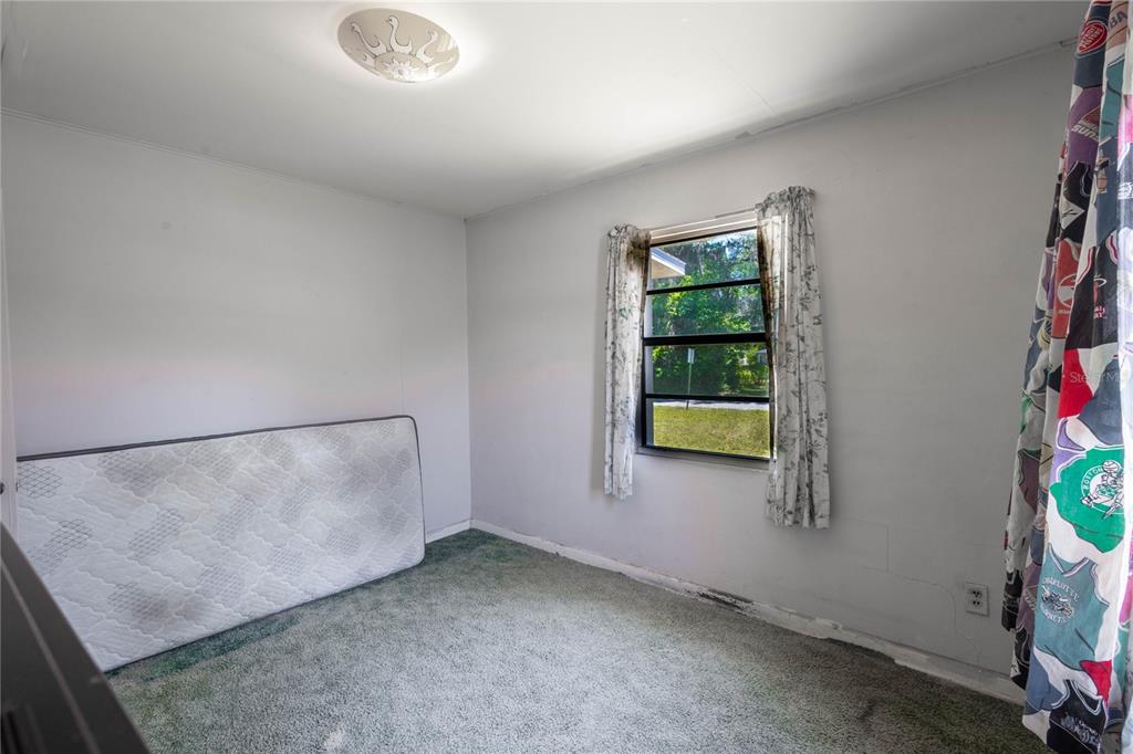 6281 Southeast Hames Road Belleview, FL 34420 - Photo 7 of 16 a view of an empty room with a window