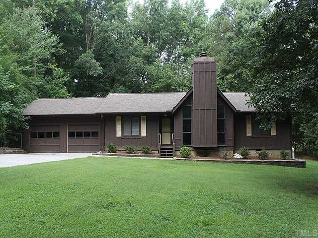 9101 Ray Road Raleigh, NC 27613 - Photo 1 of 14 a front view of a house with a yard and trees