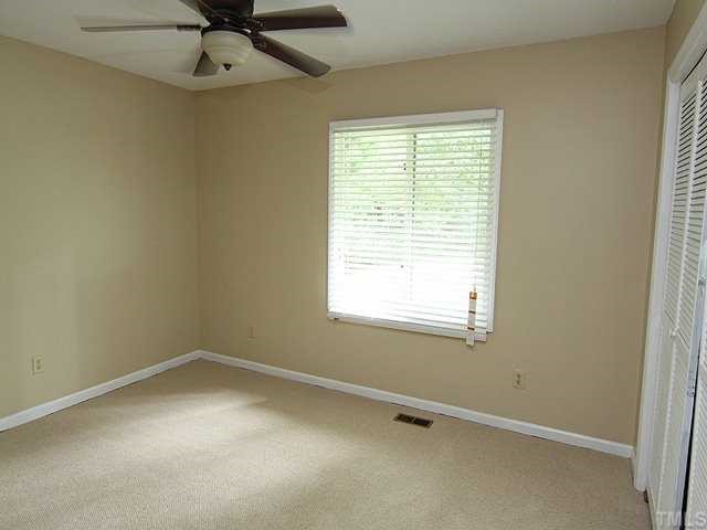 9101 Ray Road Raleigh, NC 27613 - Photo 11 of 14 an empty room with a window and a fan