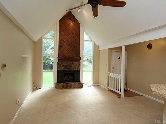9101 Ray Road Raleigh, NC 27613 - Photo 2 of 14 a view of a livingroom with a fireplace and window