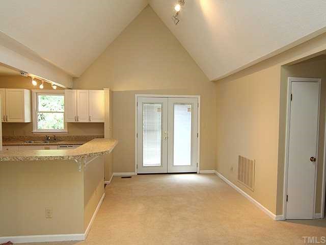 9101 Ray Road Raleigh, NC 27613 - Photo 3 of 14 a view of a kitchen with a sink and dishwasher with wooden floor