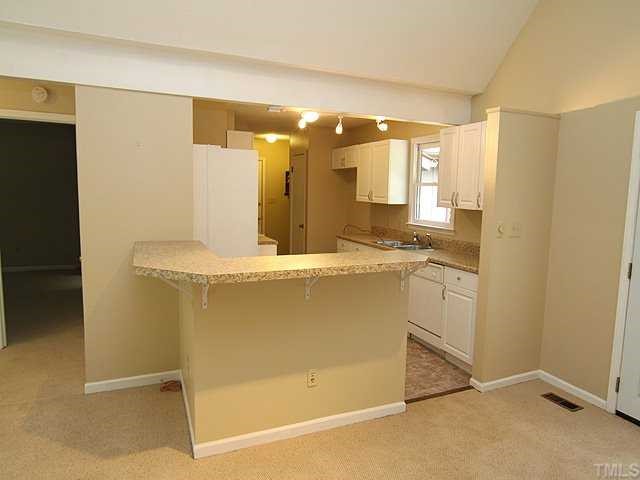 9101 Ray Road Raleigh, NC 27613 - Photo 4 of 14 a room with a sink cabinets and a mirror