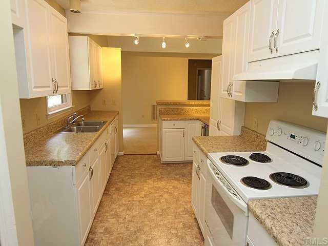 9101 Ray Road Raleigh, NC 27613 - Photo 5 of 14 a kitchen with a sink stove and cabinets
