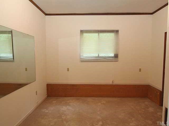 9101 Ray Road Raleigh, NC 27613 - Photo 7 of 14 an empty room with a window