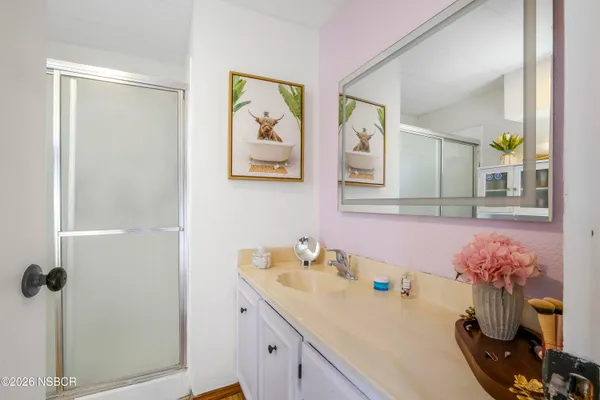 a bathroom with a granite countertop sink a mirror and vanity