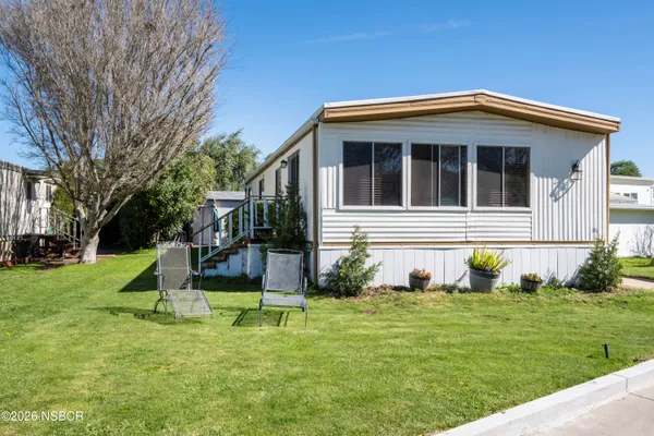 a view of house with a yard