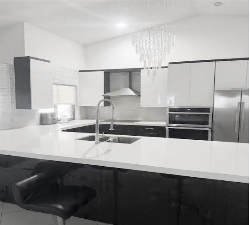 8631 Northwest 80th Street Tamarac, FL 33321 - Photo 4 of 5 a kitchen with a sink and a refrigerator