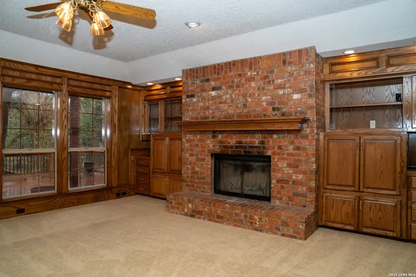 a kitchen with granite countertop white cabinets and stainless steel appliances